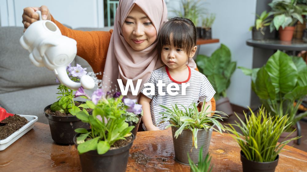 daugther sees her mother holding a watering can while watering plants